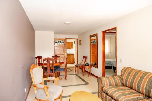 a living room with a couch and a table at Hotel San Pedro del Fuerte in Medellín