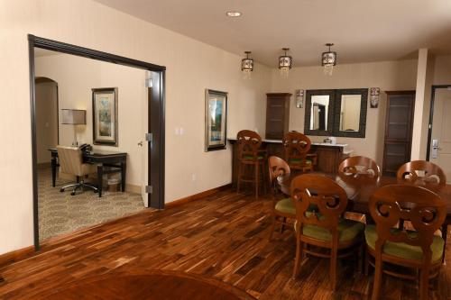 a dining room with a table and chairs at Woolley's Classic Suites in Aurora