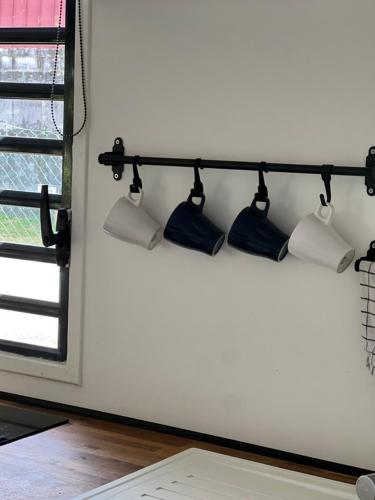 a shelf with three lights on a wall at Résidence Morphée - chaleureux avec jacuzzi in Montjoly