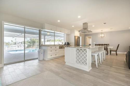 a kitchen and dining area of a home with a pool at The Seaside Retreat, FREE heated pool in Apollo Beach