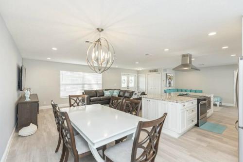 a kitchen and dining room with a white table and chairs at The Seaside Retreat, FREE heated pool in Apollo Beach