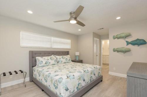 a bedroom with a bed and a ceiling fan at The Seaside Retreat, FREE heated pool in Apollo Beach