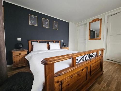 a bedroom with a large bed with white sheets at Cabana Vikingilor Bucovina in Vama
