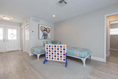 a room with two beds and a polka dot chair at The Seaside Retreat, FREE heated pool in Apollo Beach