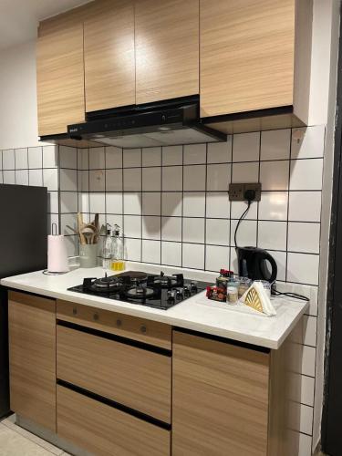 a kitchen with a stove and a counter top at Elegant & Cosy Home in Ruaka