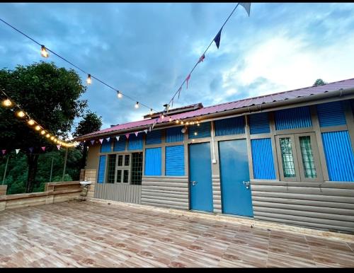 a building with blue doors and a string of lights at Holiday cabin in Sibey in Hāpoli