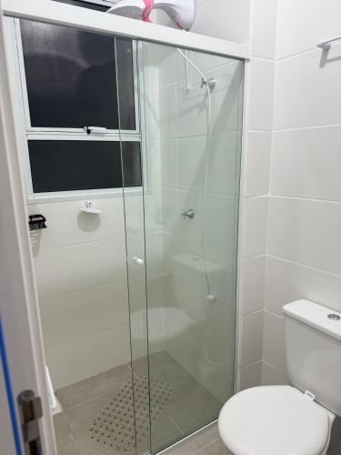 a glass shower in a bathroom with a toilet at Oceanfront apartment with beautiful view in Palhoça