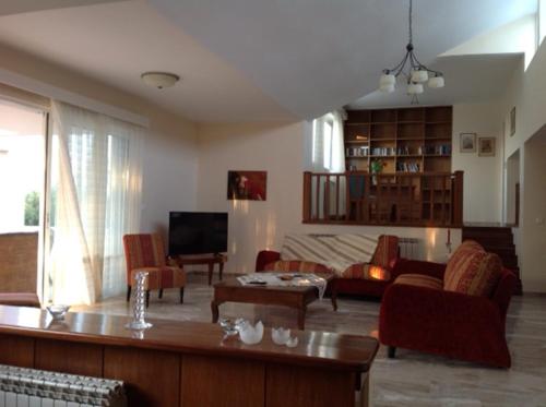 a living room with a couch and a table at Villa Leonidas in Mastichari
