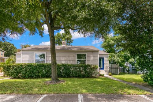 a white house with a tree in the yard at NEW SoHo Home - Perfect Space for Families in Tampa