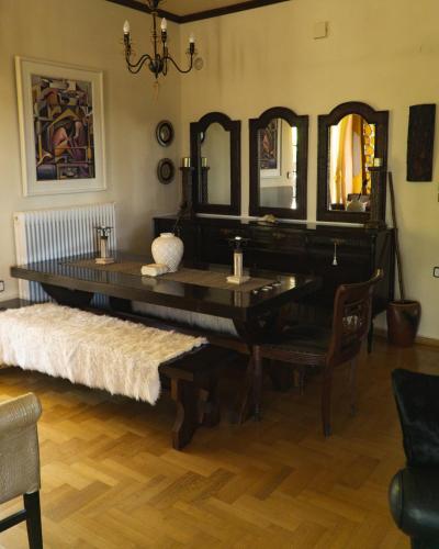 a large piano in a room with a mirror at Villa Tethys Mountain Resort in Zákas