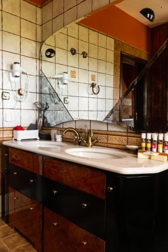 a bathroom with a sink and a mirror at Villa Tethys Mountain Resort in Zákas