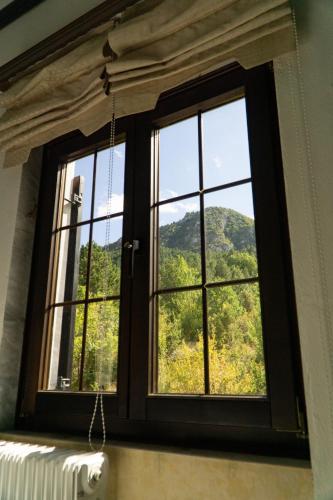 a window with a view of a mountain at Villa Tethys Mountain Resort in Zákas