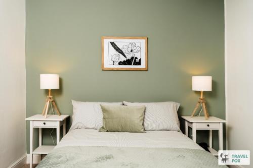 a bedroom with a bed with two night stands at Alice's Central Stay: Parking + Close to the Motor Point Arena in Nottingham