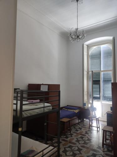 a room with a bunk bed and a window at Hostello Genovese in Genova