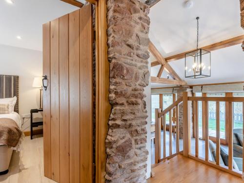 Un pilar de piedra en un dormitorio con una cama. en 3 Bed in Leominster 50517, en Pencombe