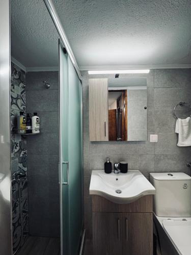 a bathroom with a sink and a shower at Porta Mesta in Chios
