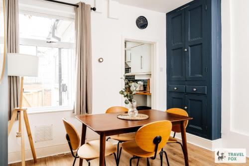 a dining room with a wooden table and chairs at Alice's Central Stay: Parking + Close to the Motor Point Arena in Nottingham