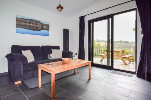 a living room with a couch and a table at Derw Bach in Llanfair Caereinion