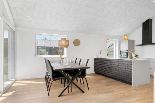 a kitchen and dining room with a table and chairs at SJ256-Haderslev-Sonderballe-Strand-83-A in Haderslev