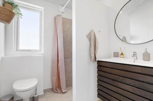 a bathroom with a toilet and a sink and a mirror at SJ256-Haderslev-Sonderballe-Strand-83-A in Haderslev
