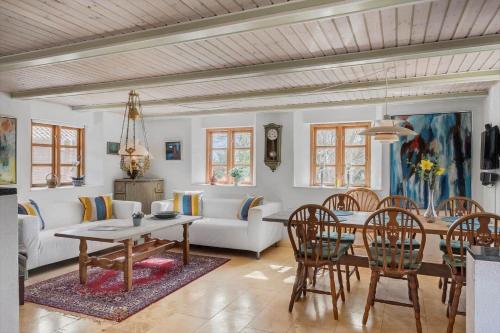 a dining room and living room with a table and chairs at SJ214-Fredericia-Lillenaes-71 in Fredericia