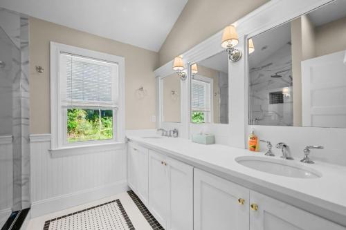 a white bathroom with a sink and a mirror at 42 Julien Road Harwich Port - Red River Retreat in Harwich Port
