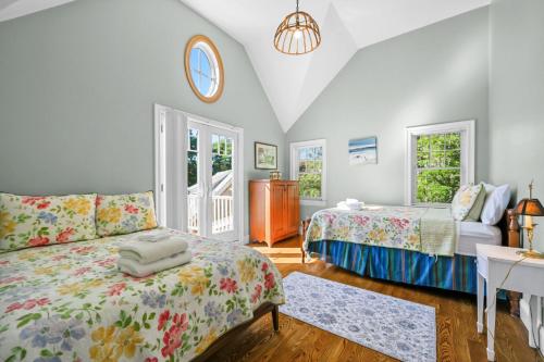 a bedroom with two beds and a desk in it at 42 Julien Road Harwich Port - Red River Retreat in Harwich Port