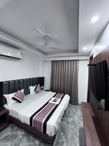a bedroom with a large bed and a television at Haveliya Homes- Just 1 minute from Railway Station and Connaught place in New Delhi