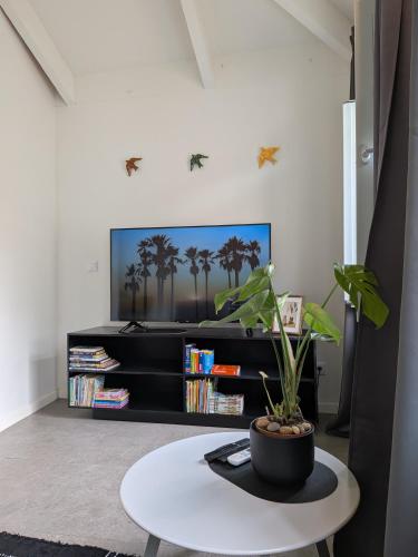 a living room with a table and a tv at Castelo River View - NEW in Vila Nova de Gaia