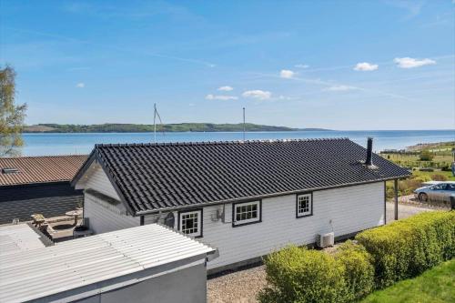 a white house with a view of the water at SJ207-Borkop-Sellerup-Strandvej-26 in Børkop