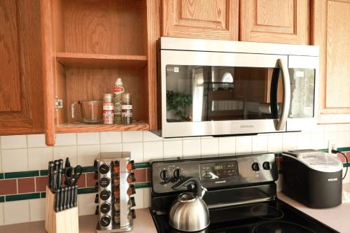 a microwave above a stove in a kitchen at Central Richland 3 bedroom in Richland