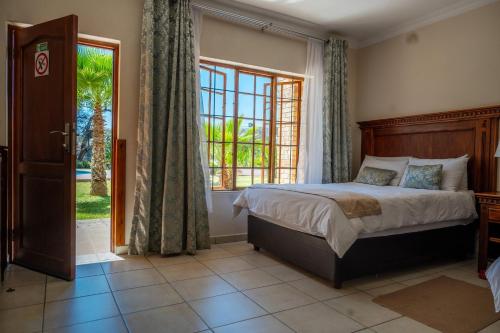 a bedroom with a bed and a large window at Kang Juliet Hotel in Kang