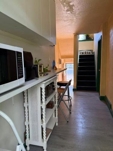 a kitchen with a counter top with a microwave at Tom home in Toronto