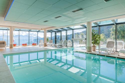 a swimming pool with a view of the mountains at Hotel Monte Bondone in Vaneze