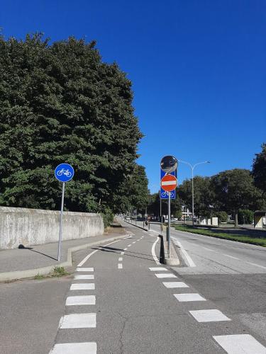 an empty street with signs on the side of the road at L'Oasi di Mario in Pinerolo