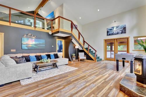 a living room with a couch and a staircase at Timberline Tranquility in Girdwood