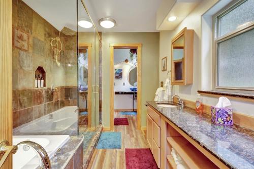 a bathroom with a tub and a sink and a shower at Timberline Tranquility in Girdwood
