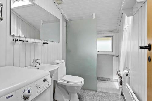 a white bathroom with a toilet and a sink at SJ253-Haderslev-Vikaerparken-89 in Haderslev