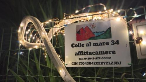 a sign is attached to a fence with lights at Colle al mare 34 - rooms & bike - affittacamere in Porto Recanati