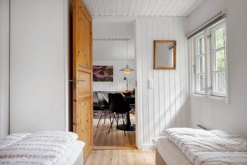 a bedroom with two beds and a table in a room at SJ259-Borkop-Pilealle-5 in Børkop