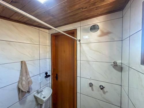 a bathroom with a shower and a toilet and a sink at Bella Mar Suítes in Angra dos Reis