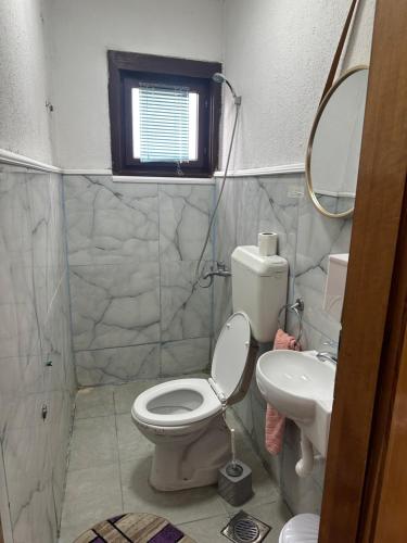 a bathroom with a toilet and a sink at Apartman Struga in Struga