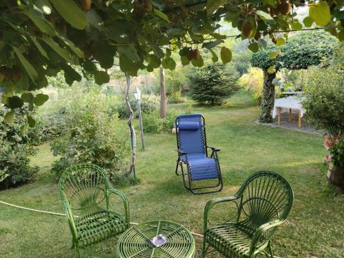 three chairs and a blue chair in a yard at I Santicelli in Morano Calabro