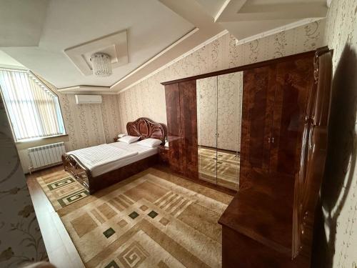 a bedroom with a bed and a shower in it at Apartments Rakhmatullaev in Samarkand
