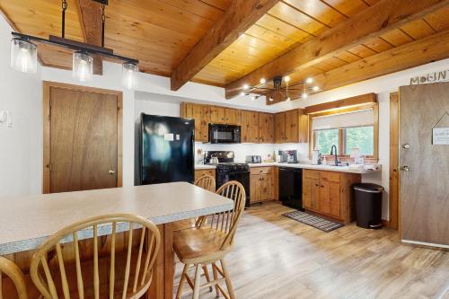 a kitchen with wooden cabinets and a table and chairs at Casa Bear Cub in Bartlett
