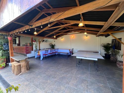 a large patio with tables and chairs in a building at Alojamiento Privado in Otavalo