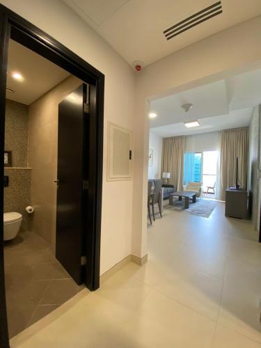 a hallway with a door leading to a dining room at Panoramic Seaview one-bedroom apartment in Abu Dhabi