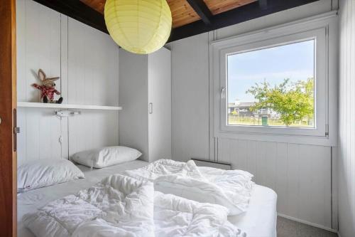 a bedroom with a large bed and a window at Sj295-Hejls-Hegnet-1 in Hejls