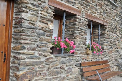 a stone building with two windows with pink flowers at Borda Cucut-HUT4-08181 in La Massana