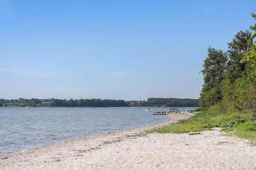 a beach with a bench on the side of the water at SJ299-Hejlsminde-Poppelvaenget-4 in Hejlsminde
